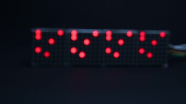 Red color LED with some movement pattern that shows the concept of data moving. Matrix display with red led and blur background