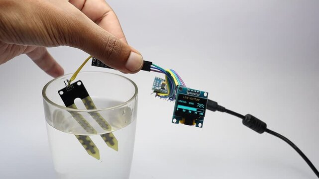OLED module or the display module showing real time water level from a glass using the moisture sensor controlled by small micro controller