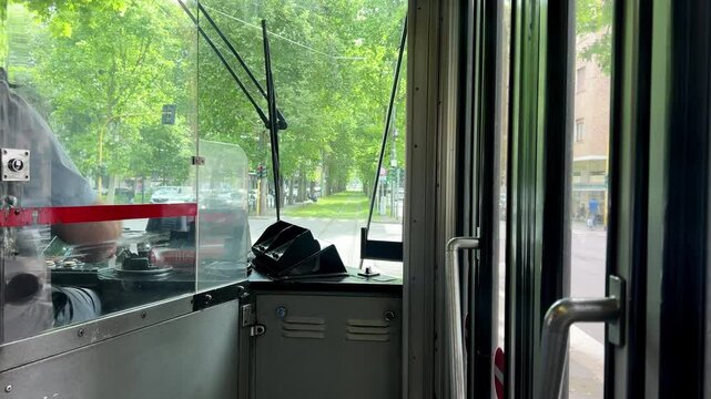 View from the driver's cab of a tram in Milan. The tram starts moving again after stopping at the traffic lights