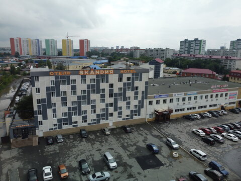 High-angle drone shot (top-down / bird's-eye view) of the Skandia Hotel in Tyumen, Russia, captured on July 21, 2022, using a DJI Mini 2. The hotel is located at 158 Shcherbakova Street in Tyumen