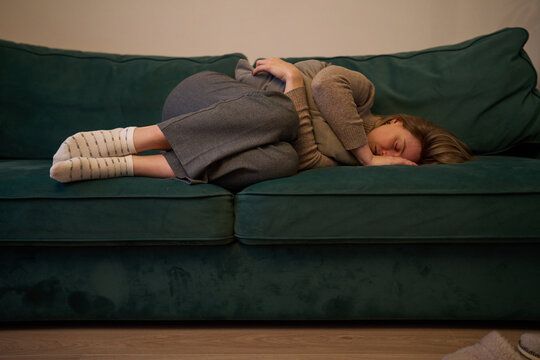 Woman holding pillow closely in a quiet moment of emotional loss