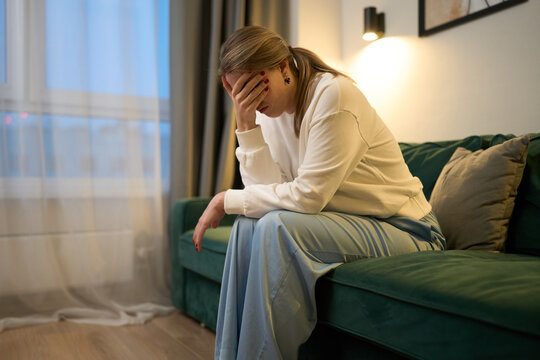 Quiet emotional collapse in a softly lit home