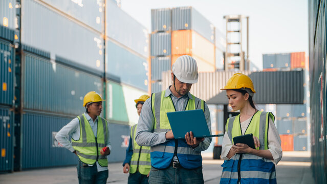 Logistics worker safety helmet reflective vest container yard freight transport logistics teamwork cargo inspection shipping management industrial technology supply chain coordination Logistics