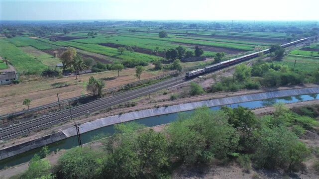 Passenger train hauled by a WAP7 electric locomotive near Pune India.