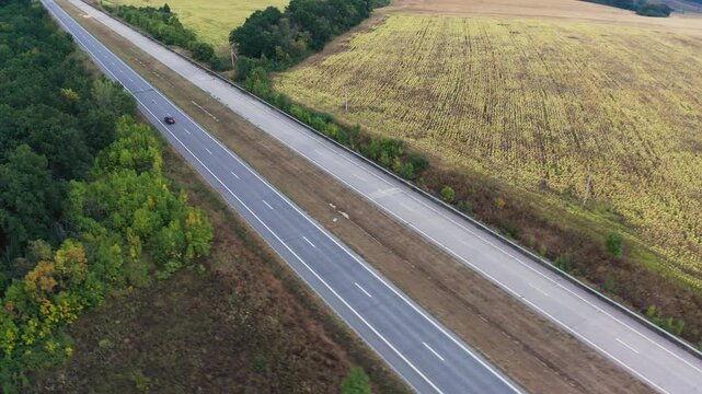 Long two-lane concrete road with traffic in rural area