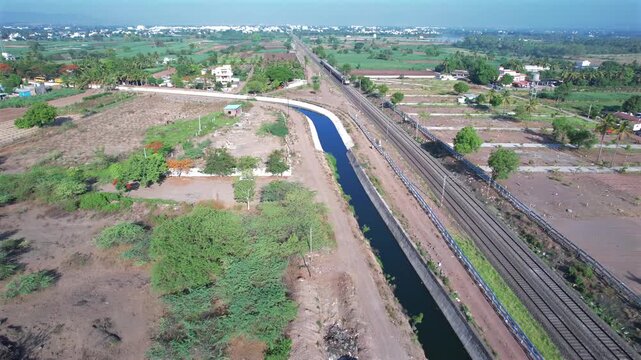 Passenger train hauled by a WAP7 electric locomotive near Pune India.