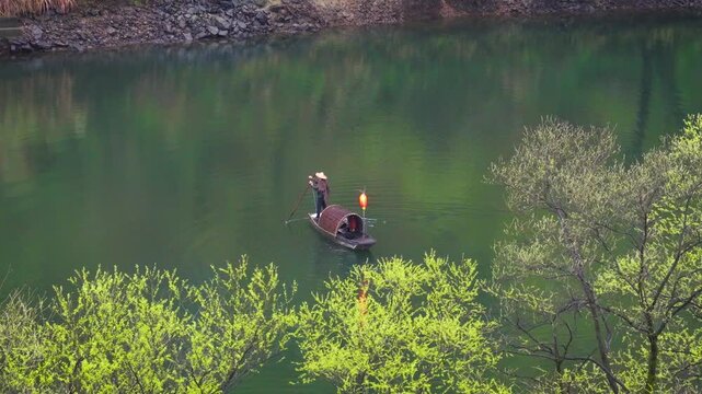 Aerial View of Fishermen cast nets to catch fish in Moon Bay at Wuyuan County, Jiangxi Province, China