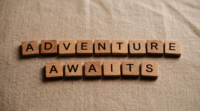 Wooden scrabble tiles spell out adventure awaits on a textured background