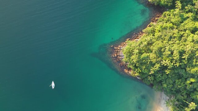Aerial view of the spearfisherman hunting in the sea. Aerial top down view of the hunter in the water