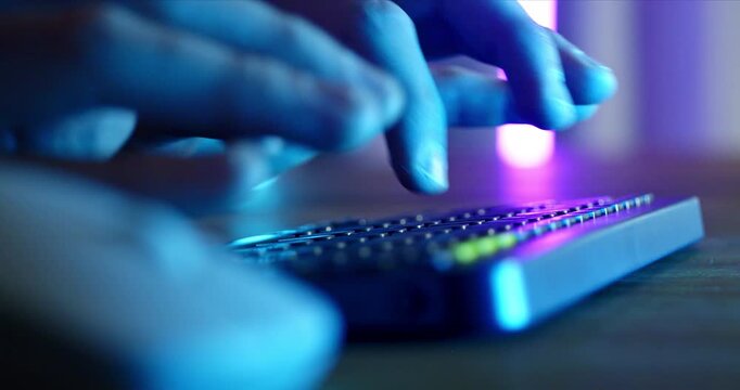 Close Up Of Hands Using Computer Keyboard And Mouse With Neon Blue Lighting, Creative Designer Working Late At Night In Digital Studio
