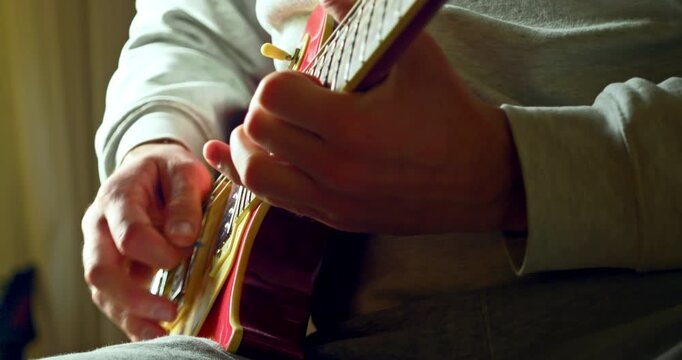 Slow Motion Close Up Of Hands Playing Electric Guitar In Warm Natural Light, Musician Practicing Instrument At Home