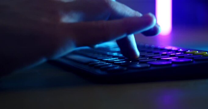 Slow Motion Of Hands Operating Audio Mixer And Computer Keyboard In Neon Studio, Music Production And Sound Engineering Concept
