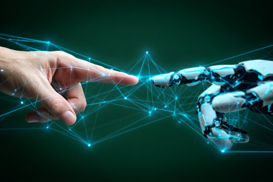 human hand and robot finger pointing touching with glowing blue network connections