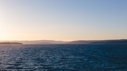 Fototapeta premium Sailing out of Oslofjord approaching Golden Hour, Oslo, Norway, April 2026