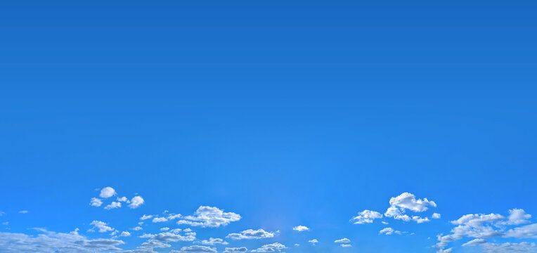 A vast sky for a banner. Free area for inscriptions. A cosmic scale for viewing the volume of air. A panorama of high-altitude cirrus and cumulus clouds. Blue sky background. Big copy space for text.