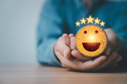 Customer satisfaction concept with smiling face and five star rating in hands, represent positive feedback, service quality, user experience, business trust, review system and client happiness