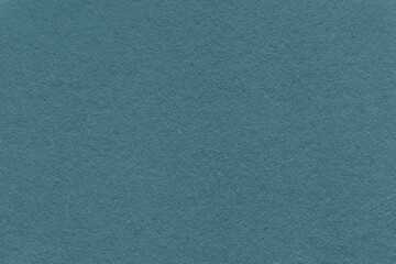 Fototapeta premium Dark teal textured paper background with subtle grain surface and soft structure. Muted teal backdrop, macro