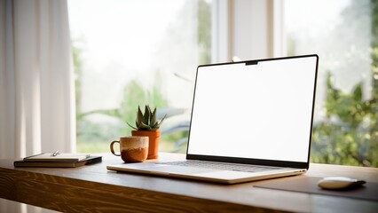 Naklejka premium Laptop Blank Screen Mockup on Desk in Bright Modern Home Office - Angled View