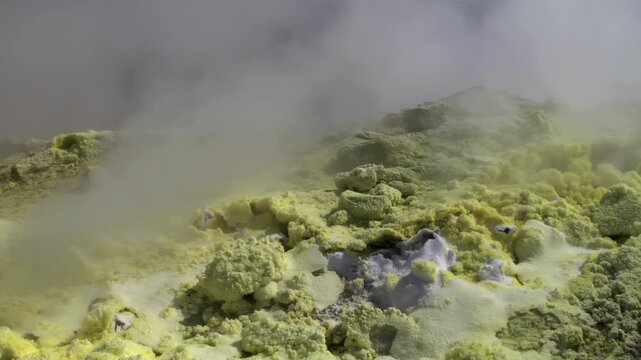 Close-up of vibrant yellow sulfur crystals on a fumarole field. Natural mineral deposits on the slopes of Vulcano Islands, Italy.