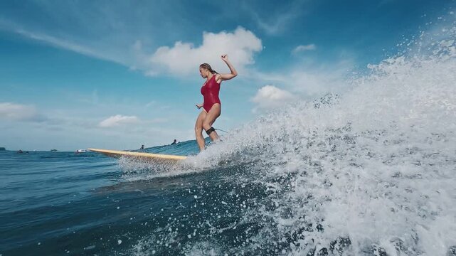 Woman surfer rides the wave in the Maldives