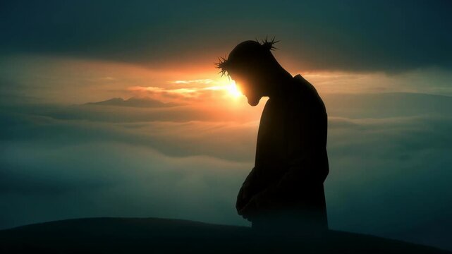 Silhouette of a person wearing a crown of thorns at sunrise over misty mountains with dramatic sky