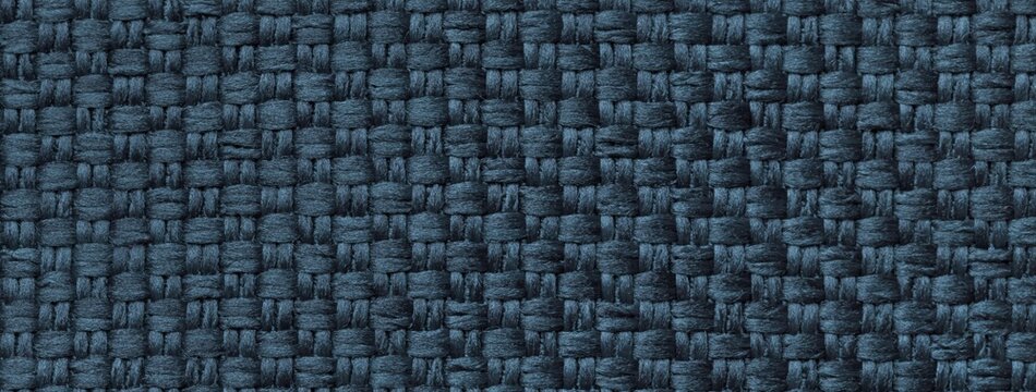Dark blue woven textile texture background, macro. Structure of navy fabric material backdrop with weave pattern