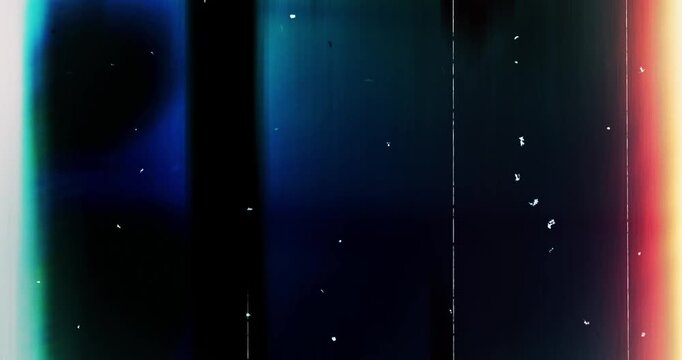 Overlaying a black background with glare on a screen image with scratches and white dots from dust.