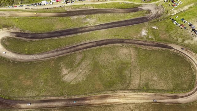 Auto Cross Race on Dirt Track Seen from Above, Aerial Sports Concept with Racing Cars and Dust Clouds, Drone View of Off-Road Competition