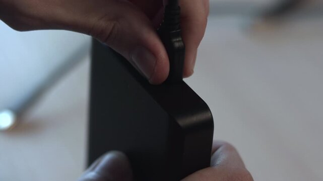 Examining USB Port. Closeup Shot Of Reviewer Inspecting USB Port On Small Hub Device With Focused Attention. Media
