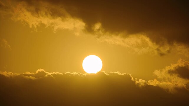 A beautiful spring dawn in Keelung, Taiwan, featuring the sun peeking through dramatic dark clouds in the morning sky.
