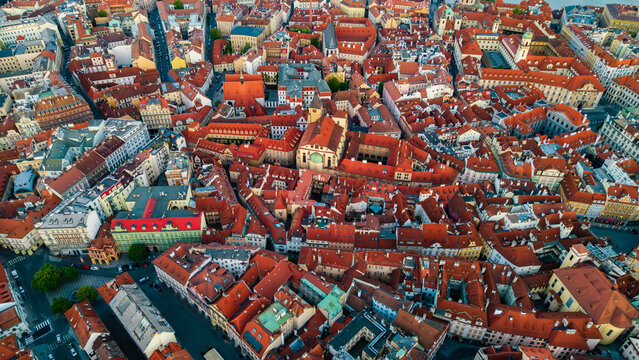 Aerial view of the historic Old Town with its dense cluster of red tiled rooftops, narrow winding streets, and traditional architecture under soft daylight in Prague, Prague, Czechia.