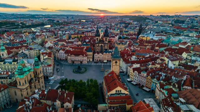 Aerial view of Old Town Square featuring the Church of Our Lady before Tyn and historic red rooftops during a golden sunset in Prague, Prague, Czechia.