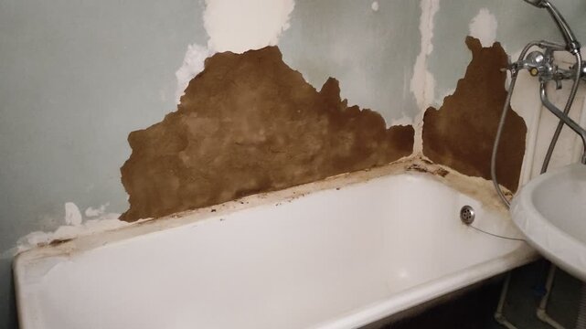 Old bathroom ready for renovation, chipped plaster walls, retro video effect with particles