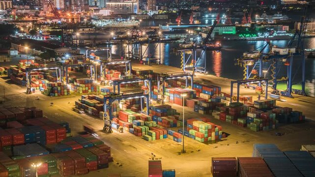 Night view time-lapse of container terminal working scene at Xiuying Port, Haikou, China, busy seaport crane logistics at night