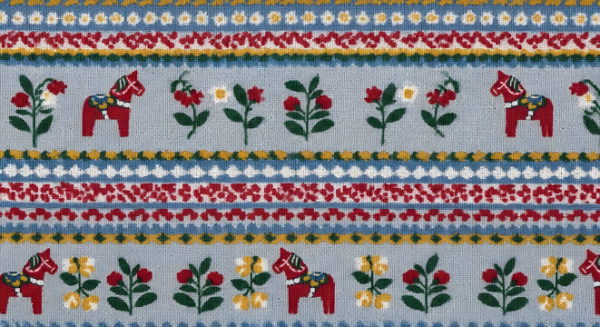 Celebrating National Day of Sweden with traditional Dala horses, flowers, and folk patterns on a rustic wooden surface, showcasing cultural heritage and festive decorations.