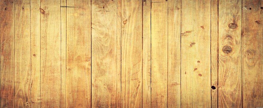 Vertical light brown wooden planks with natural grain patterns, knots and subtle color variations create a warm rustic textured surface filling the entire frame.
