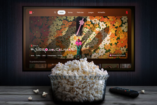 Cali, Colombia - May 5 2026: Netflix app on tv screen playing "El Juego del calamar" (Squid Game) behind a bowl of popcorn and a remote control.