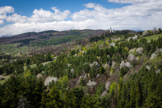 Breathtaking spring view of the Marianska hora pilgrimage site in Levoca, with the snow-capped High Tatras mountains in the background
