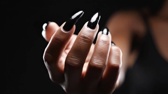 Close Up Of Female Hand Flexing Fingers With Long Black Creature Claws