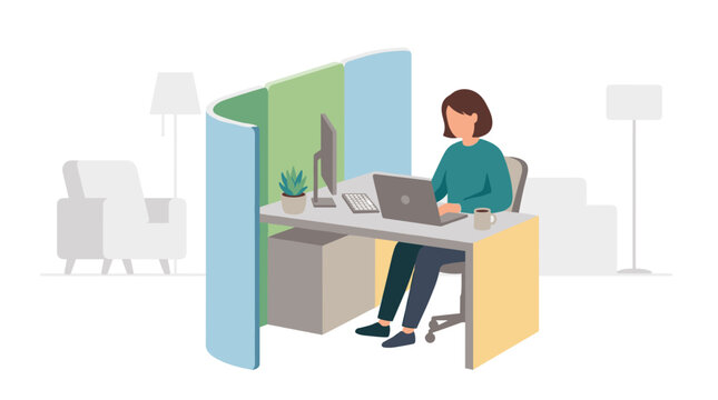 Person working at desk inside modern office cubicle.