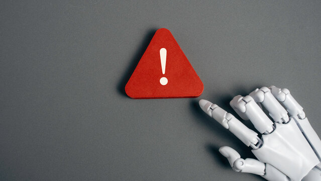 Robot Hand Touching Red Warning Exclamation Mark Sign for Artificial Intelligence Error and Machine Learning Risk Concept