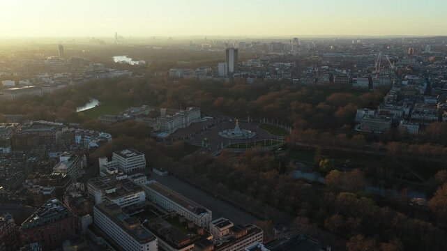 Warm sunrise casting long shadows over the Wellington Arch, Buckingham Palace, Hyde Park, with the City of London skyline and Mayfair and Westminster boroughs background