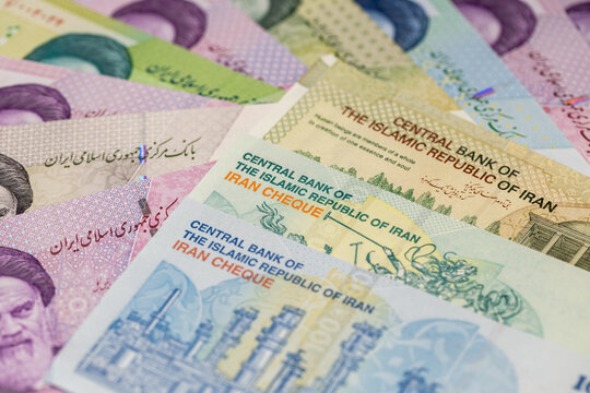 Iranian currency. Economic concept, financial situation. New toman banknotes and older rials. Business background. Close up