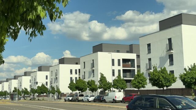 Madrid, Spain,May 4 2026, modern architecture, Contemporary white residential buildings lining a street in a suburban neighborhood of Madrid