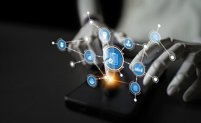 A close-up view of hands interacting with a smartphone, surrounded by floating digital icons that symbolize data connections and modern technology in a contemporary workspace. Tessel © InfiniteFlow