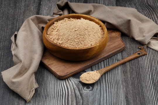 Organic Oleaster Seed Powder in a Rustic Wooden Bowl on a wooden Background for Healthy Living