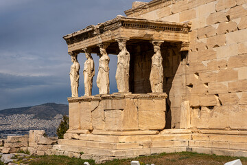 Fototapeta premium A detailed view of the iconic Porch of the Maidens (Caryatids) at the Erechtheion temple on the Acropolis of Athens, Greece. The six female statues serve as architectural columns supporting the roof, 