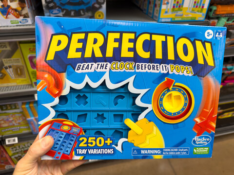 Hasbro Perfection Board Game Box Held in Retail Store