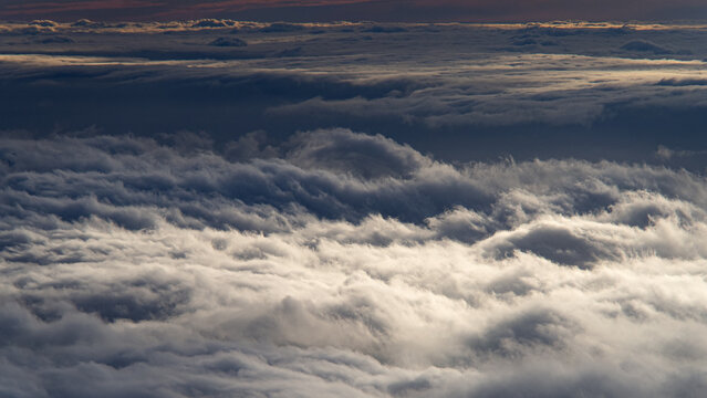 Sea of clouds from above at sunset