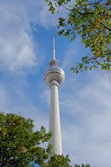 Obraz premium low angle view on Berlin TV tower framed by trees